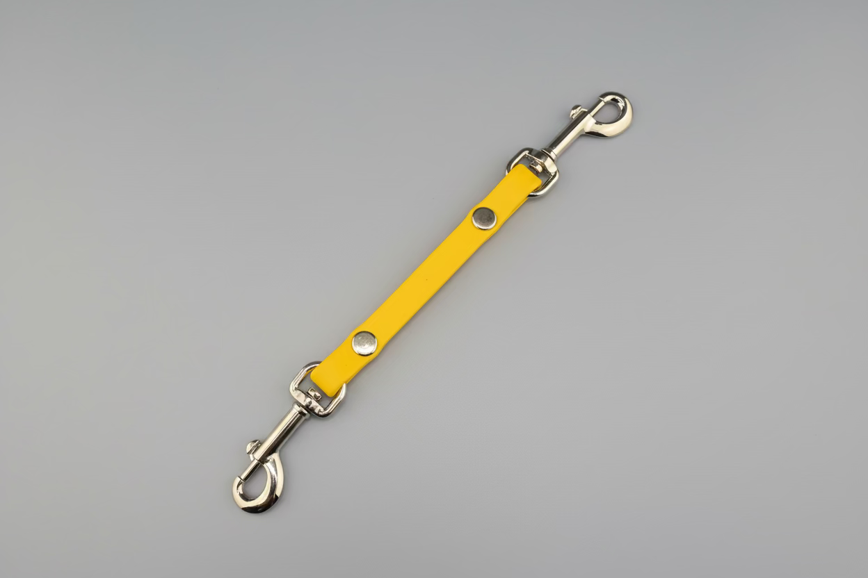 Yellow leather strap with metal hardware on a black background