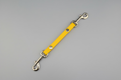 Yellow leather strap with metal hardware on a black background